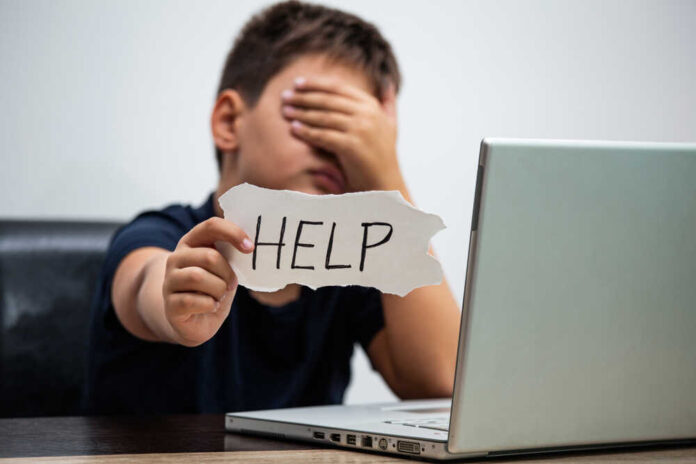 Sad,And,Scared,Young,Boy,With,Computer,Laptop,Suffering,Cyberbullying