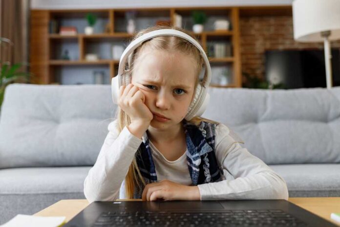 Cute,Child,Studying,Remotely,At,Home,Using,Laptop.,Tired,Primary