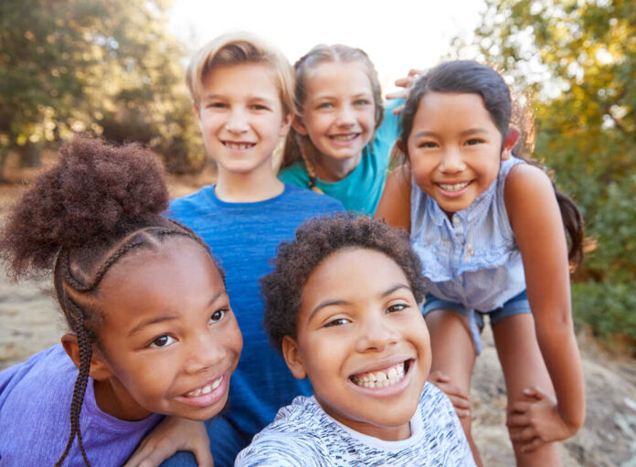 Portrait,Of,Multi-cultural,Children,Hanging,Out,With,Friends,In,Countryside