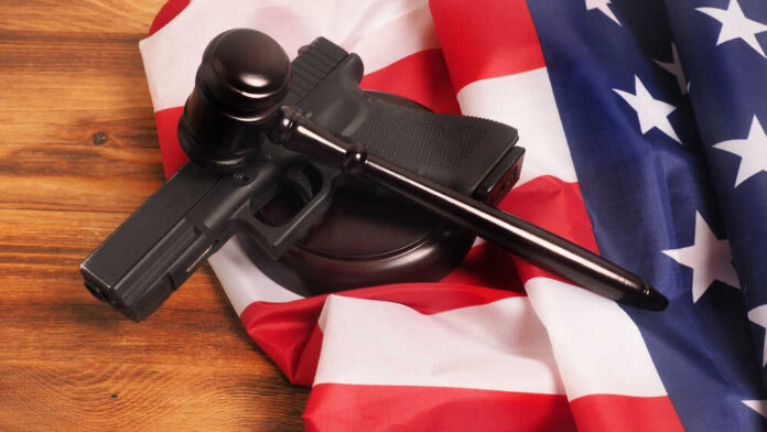 Judge,Gavel,And,Gun,On,Usa,Flag.,Gun,Law,Concept
