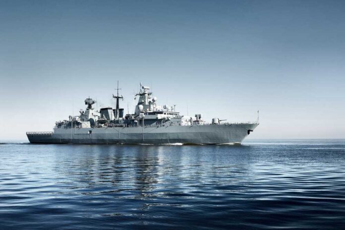 Grey,Modern,Warship,Sailing,In,Still,Water