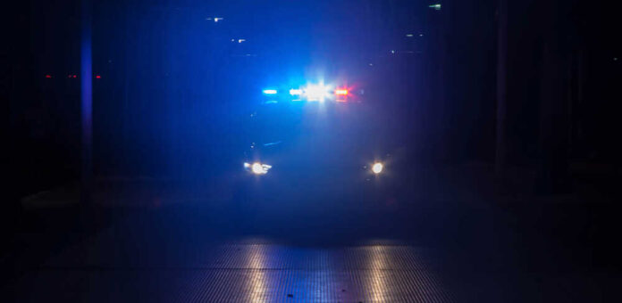 Police,Car,With,Their,Lights,On,Flashing,Red,And,Blue