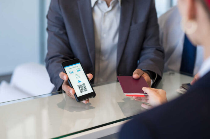 Closeup,Hand,Of,Man,Showing,Flight,Ticket,To,Staff,On