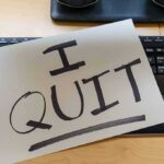 Olympus Corporation Faces Turmoil After CEO Resignation Amid Drug Allegations Paper with "I QUIT" on keyboard.