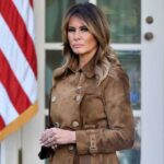 Melania Trump’s Non-Traditional Approach to a Potential Return to the White House Woman in brown coat near American flag.