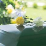 Flowers resting on a casket lid.
