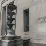 Department of Justice building with stone sculpture.