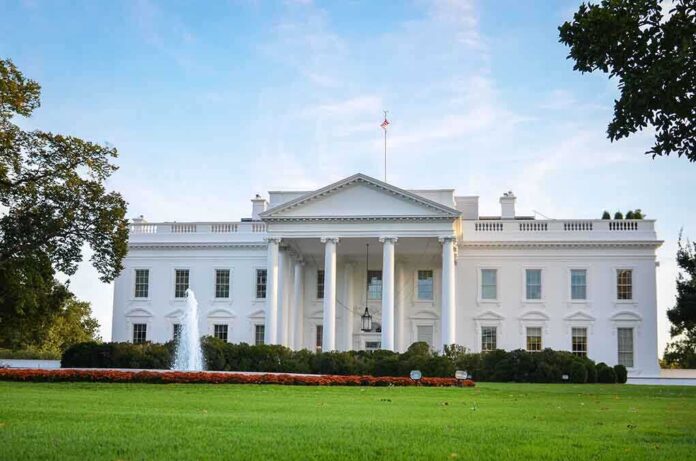 116515852 featured image White house with fountain and flags, front view.