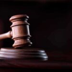 Wooden gavel on a dark background.