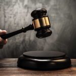 Judge's gavel hitting a sound block.