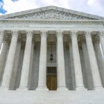 Arizona Supreme Court Suspends Prosecutor Over Misconduct Claims Building with columns under a cloudy sky.