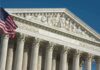 US Supreme Court building with American flag