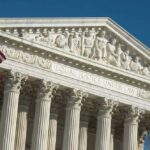 US Supreme Court building with American flag