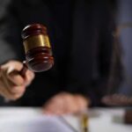 Judge using gavel in courtroom.