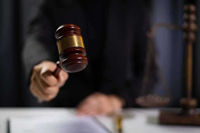 2477750649 featured image Judge using gavel in courtroom.