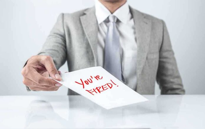 483667948 featured image Person handing a paper with "You're Fired!" text.