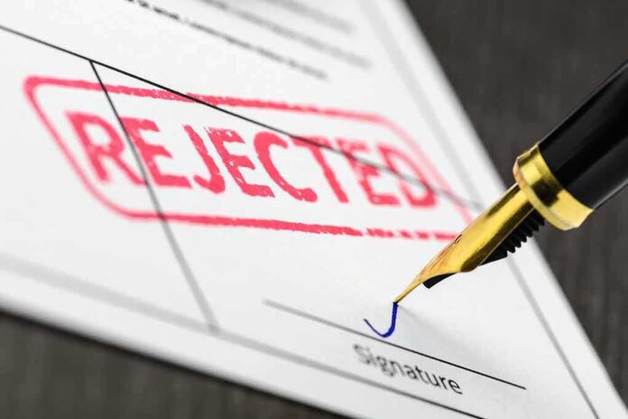 645114751 featured image Rejected stamp on a document with pen.