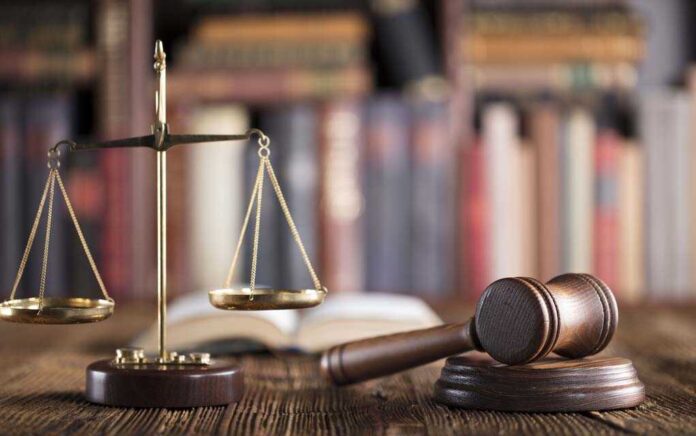 666508099 featured image Gavel and scales on desk with books.