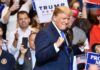 Man in suit standing at a rally event