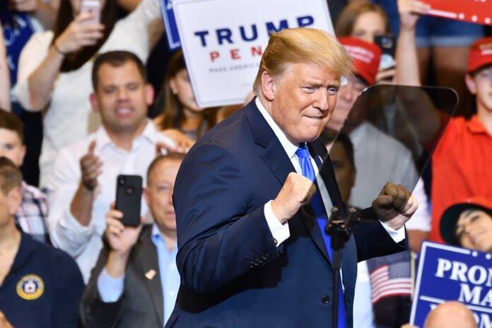 1148319815 featured image Man gesturing at rally surrounded by supporters