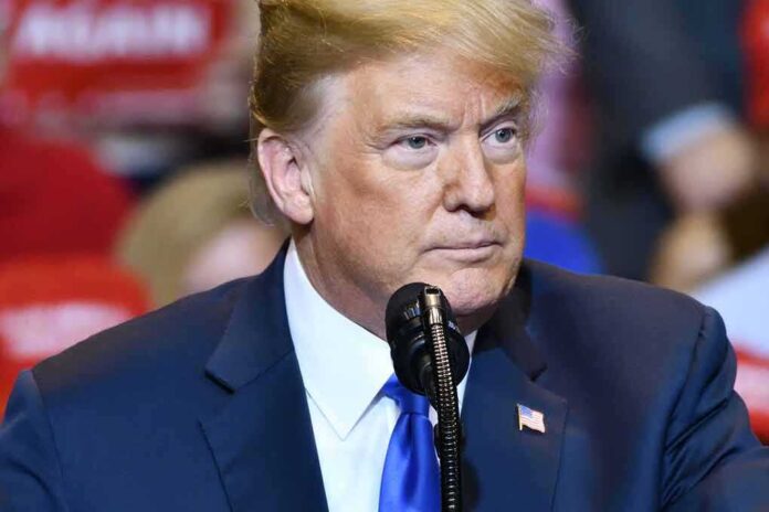 Man speaking at a rally in blue suit