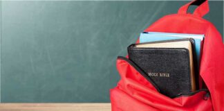 Red backpack with a Bible and books inside