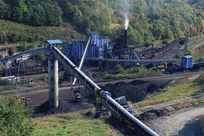 136340531 featured image Industrial coal processing plant with conveyor belts and smokestack.