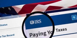 Magnifying glass over IRS website for paying taxes