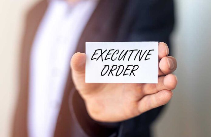 1906328002 featured image Man holding card saying executive order