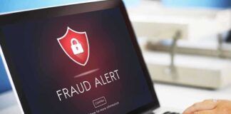 Laptop displaying fraud alert warning on screen