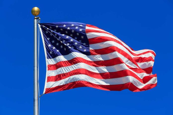 American flag waving against clear blue sky