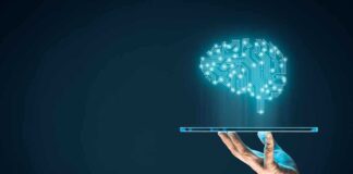 Hand holding tablet projecting digital brain hologram