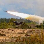 Military tank firing a missile in forest area