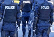 Police officers in riot gear with shields