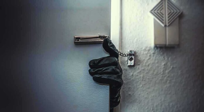 576370024 featured image Gloved hand opening door with security chain
