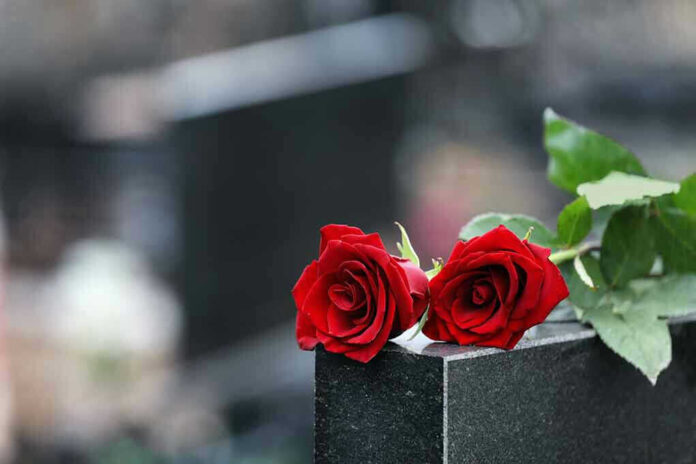 Two red roses on a gravestone