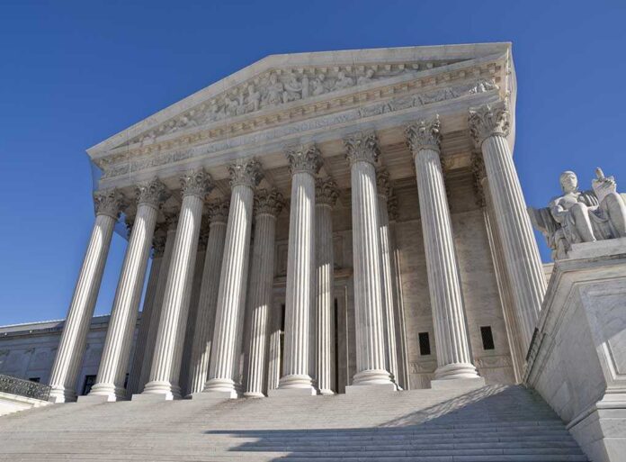 shutterstock_56445421.jpg The Supreme Court building featuring grand columns and statues under a clear blue sky
