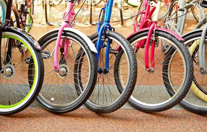 A row of colorful bicycles parked, showcasing their wheels and frames