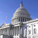 The US Capitol building with a clear blue sky in the background
