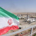 Iranian flag near an industrial gas refinery