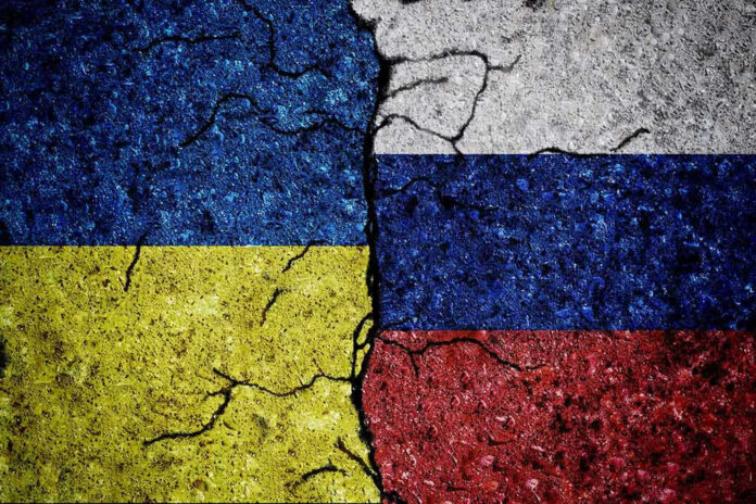 Cracked Ukrainian and Russian flags painted on concrete