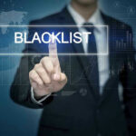 Man pressing virtual blacklist button