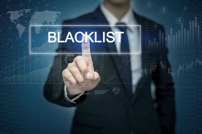 Man pressing virtual blacklist button