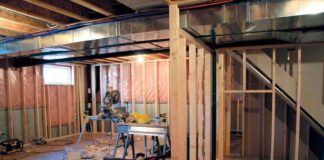 Interior of a basement under construction with wooden frames and tools