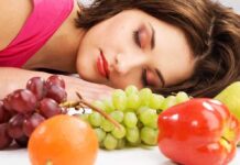 Morning Hunger Mystery—Beyond Midnight Snacks A woman resting her head on a table surrounded by various fruits