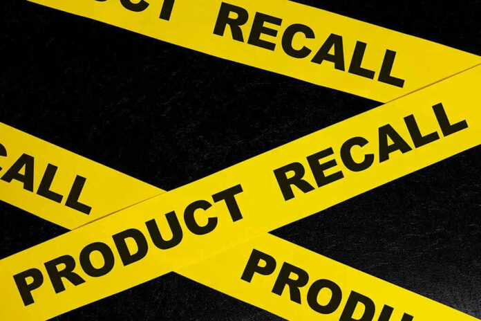 Yellow tape with product recall text on black background