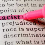 Racist highlighted in pink marker in a book