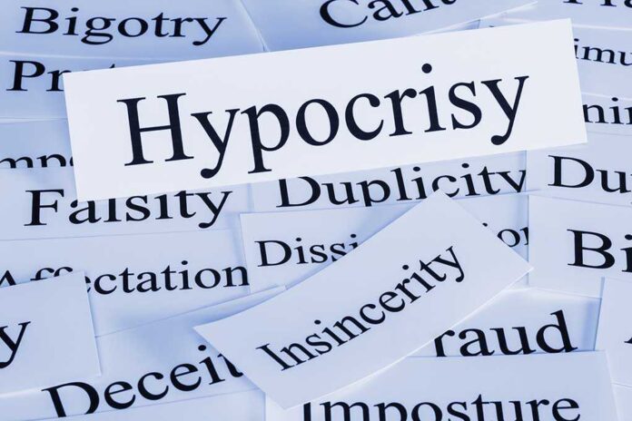 A collection of paper cards with various negative terms,prominently featuring the word Hypocrisy