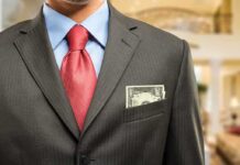 “Old Money” Secrets REVEALED: Why They’re Happier Man in a suit with a red tie and money peeking from his pocket