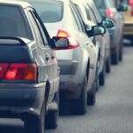 A line of cars stuck in traffic on a roadway